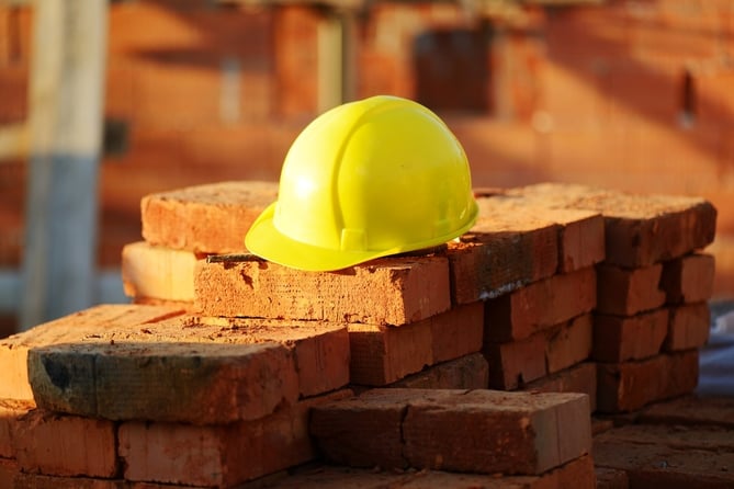 Under construction, helmet and bricks for building site.jpeg