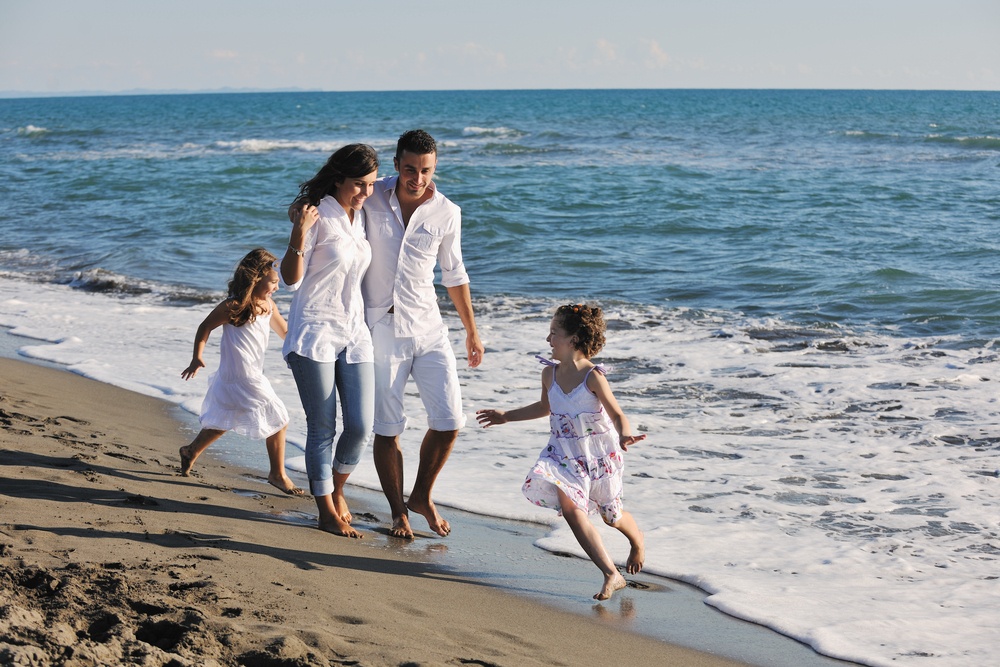 happy young family in white clothing have fun at vacations on beautiful beach.jpeg